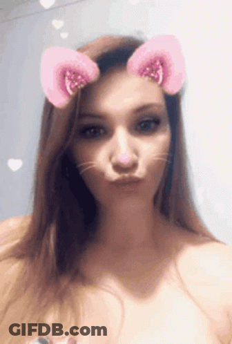 A Woman With Cat Ears On Her Head Making A Funny Face GIF