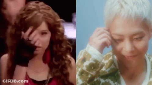 A Woman With Curly Hair And A Man With White Hair Are Standing Next To Each Other And Looking At Each Other . GIF