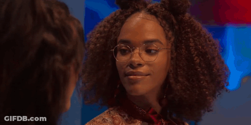A Woman With Curly Hair And Glasses Says I 'M Speaking Into The Universe GIF