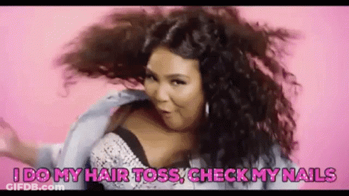 A Woman With Curly Hair Is Dancing On A Pink Background . GIF
