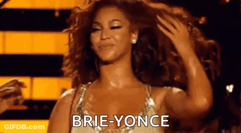 A Woman With Curly Hair Is Holding Her Hair And Says Brie-Yonce On The Screen . GIF