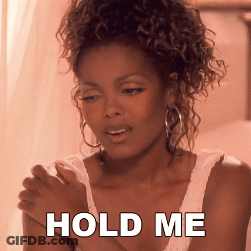 A Woman With Curly Hair Is Holding Her Hands Together With The Words Hold Me Below Her GIF