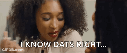 A Woman With Curly Hair Is Looking At Herself In The Mirror And Saying `` I Know Dats Right '' . GIF