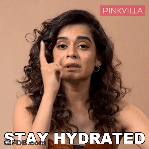 A Woman With Curly Hair Is Making A Funny Face And Says " Stay Hydrated " GIF