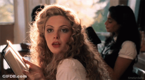 A Woman With Curly Hair Is Reading A Book And The Words Timelordwho Are Visible In The Corner GIF