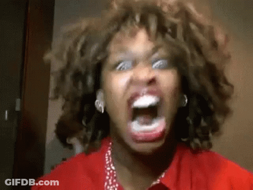 A Woman With Curly Hair Is Screaming With Her Mouth Open . GIF