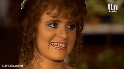 A Woman With Curly Hair Is Smiling With A Tln Logo In The Background . GIF