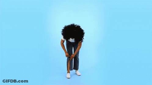 A Woman With Curly Hair Is Standing On A Blue Background With Her Head In The Air . GIF