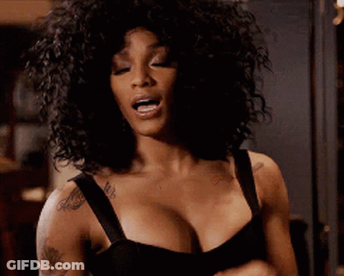 A Woman With Curly Hair Is Wearing A Black Bra And Has A Tattoo On Her Arm . GIF
