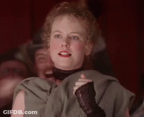 A Woman With Curly Hair Is Wearing A Black Glove GIF