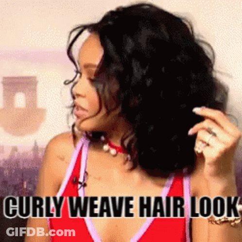 A Woman With Curly Hair Is Wearing A Red Tank Top And A Necklace . GIF