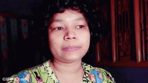 A Woman With Curly Hair Is Wearing A Shirt That Says ' On ' On The Front GIF