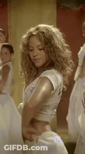A Woman With Curly Hair Is Wearing A White Crop Top With The Number 4 On It GIF