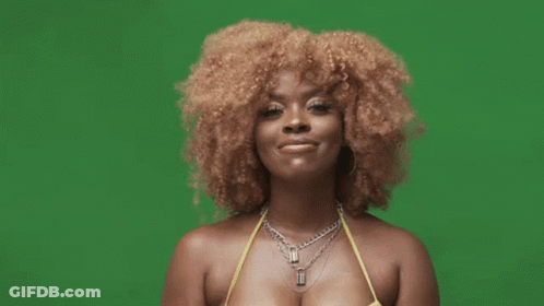 A Woman With Curly Hair Is Wearing A Yellow Bikini And A Black Glove . GIF