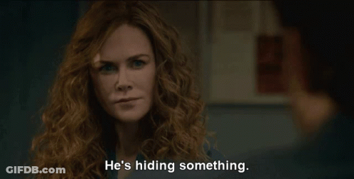 A Woman With Curly Hair Says He 'S Hiding Something In Front Of A Man GIF