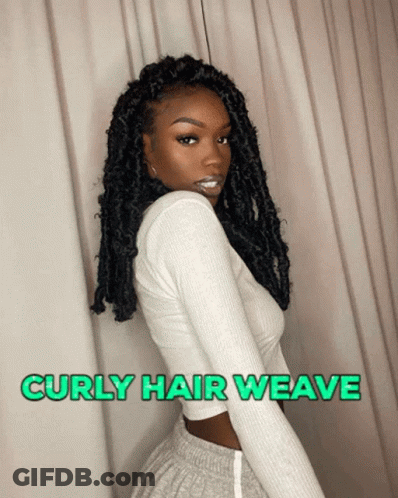 A Woman With Curly Hair Wearing A White Shirt And Grey Shorts GIF