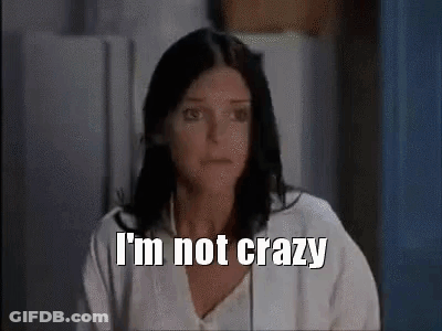 A Woman With Dark Hair Is Sitting In Front Of A Refrigerator And Says `` I 'M Not Crazy '' . GIF
