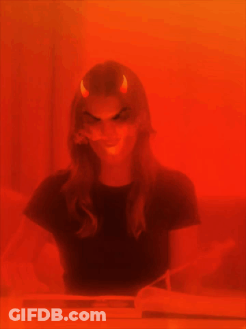 A Woman With Devil Horns On Her Head GIF