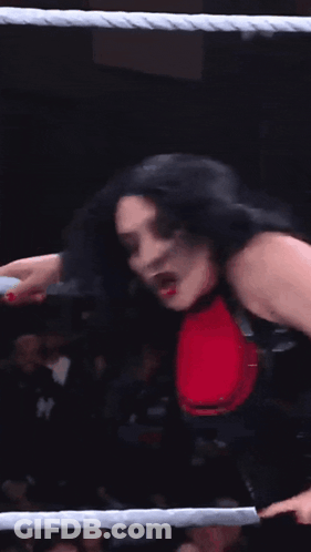 A Woman With Devil Horns On Her Head Is In A Ring GIF