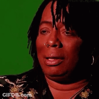 A Woman With Dreadlocks And A Nose Ring Is Crying . GIF