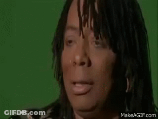 A Woman With Dreadlocks And A Nose Ring Is Making A Funny Face . GIF