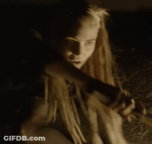 A Woman With Dreadlocks Is Holding A Candle In Her Hand GIF