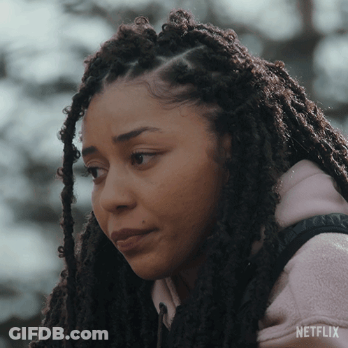 A Woman With Dreadlocks Is Wearing A Pink Netflix Hoodie GIF