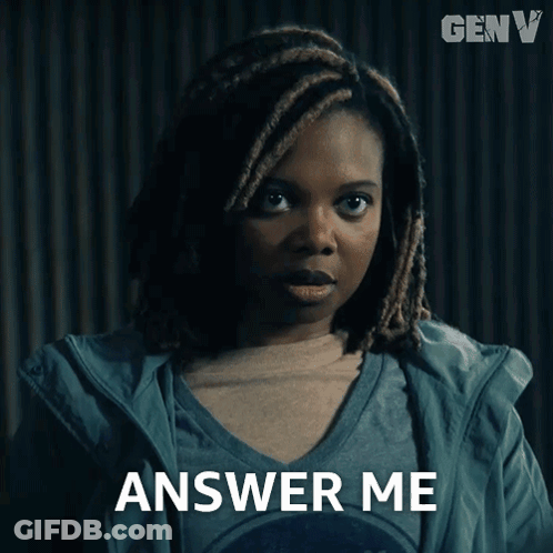 A Woman With Dreadlocks Says Answer Me In Front Of A Genv Logo GIF