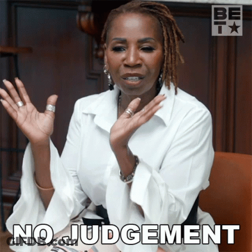 A Woman With Dreadlocks Says No Judgement With Her Hands Up GIF