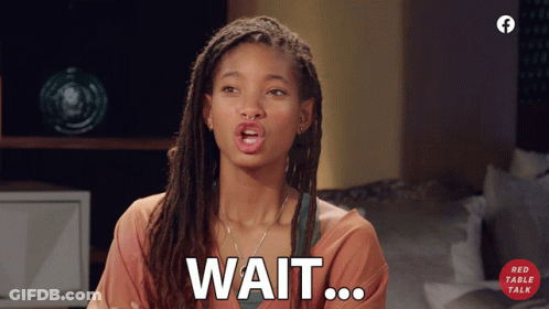A Woman With Dreadlocks Says Wait On A Red Table Talk Advertisement GIF