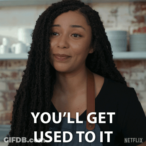 A Woman With Dreadlocks Says " You 'Ll Get Used To It " In White Letters GIF