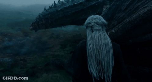 A Woman With Dreadlocks Stands In Front Of A Monster GIF