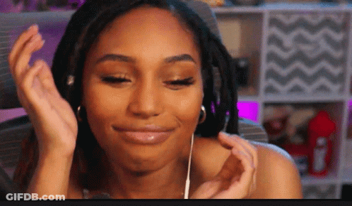A Woman With Dreadlocks Wearing Headphones And A Smile On Her Face GIF