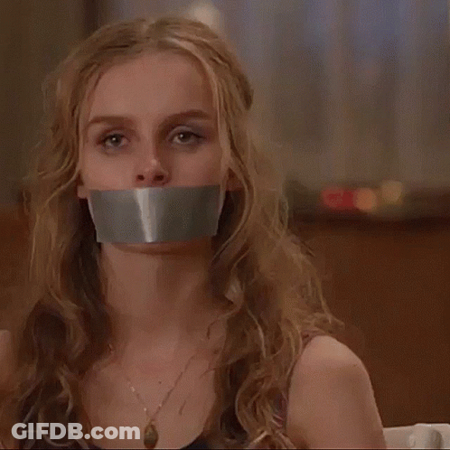 A Woman With Duct Tape On Her Mouth Is Sitting In A Chair . GIF