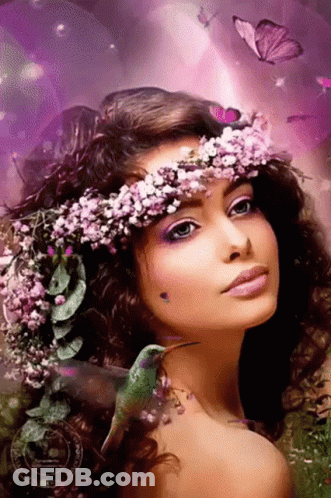 A Woman With Flowers In Her Hair And A Hummingbird On Her Shoulder . GIF