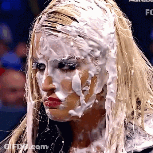 A Woman With Foam On Her Face Has The Letters Fc On The Bottom GIF