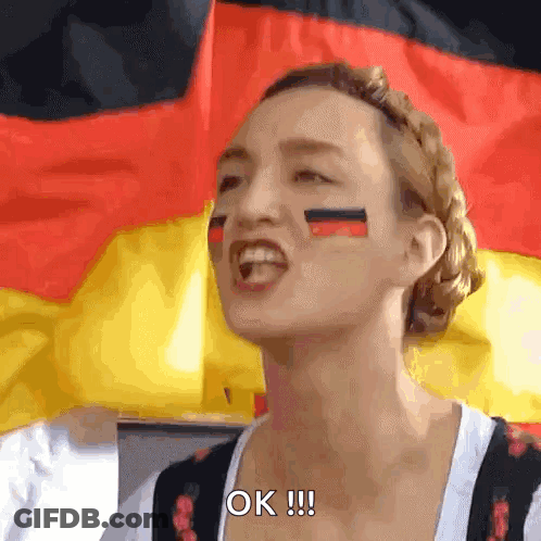 A Woman With German Flags Painted On Her Face Says Ok GIF