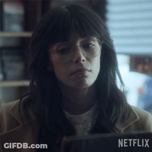 A Woman With Glasses And A Netflix Logo In The Background GIF