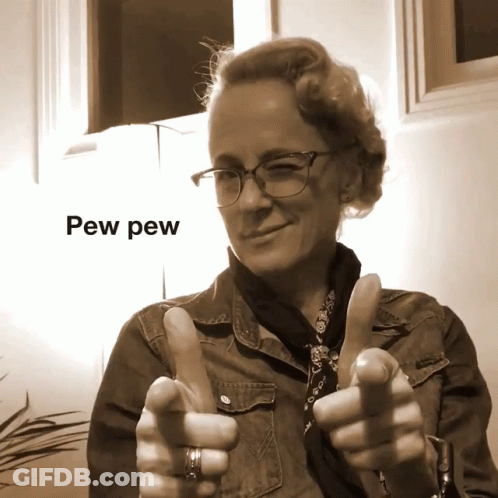 A Woman With Glasses Giving A Thumbs Up With Pew Pew Written Above Her GIF