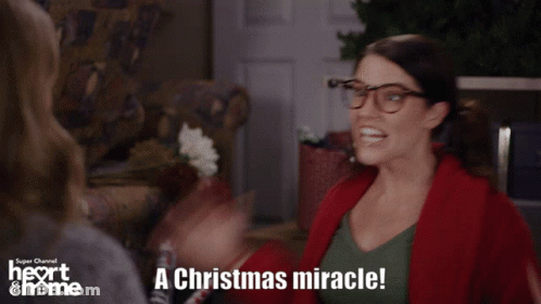 A Woman With Glasses Says A Christmas Miracle In A Super Channel Ad GIF