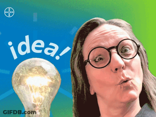 A Woman With Glasses Stands In Front Of A Light Bulb That Says Idea On It GIF