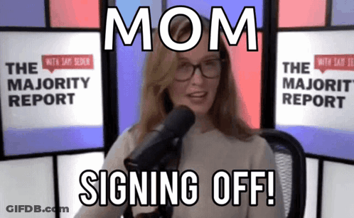 A Woman With Glasses Stands In Front Of A Microphone And Says Mom Signing Off GIF
