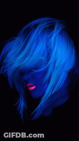 A Woman With Glow In The Dark Hair And Pink Lips GIF