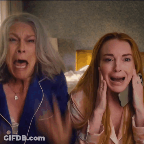 A Woman With Gray Hair And A Woman With Red Hair Screaming GIF