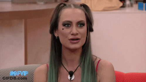 A Woman With Green Hair Is Sitting On A Couch With #Gfvip Written In Blue GIF