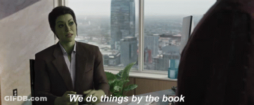Green Woman Sitting At Desk With We Do Things By The Book GIF