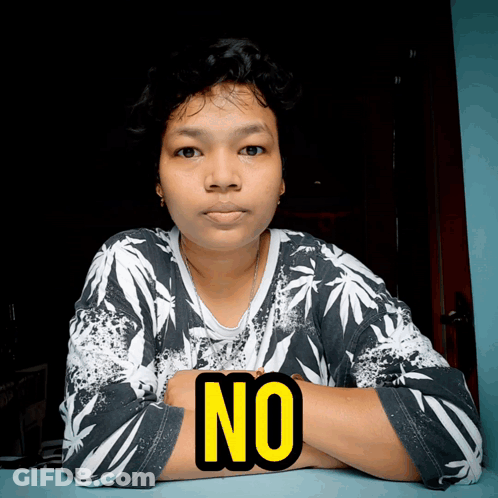 A Woman With Her Arms Crossed And The Word No On Her Chest GIF