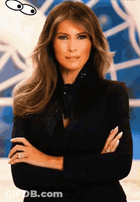 A Woman With Her Arms Crossed Is Wearing A Black Jacket And A Ring GIF
