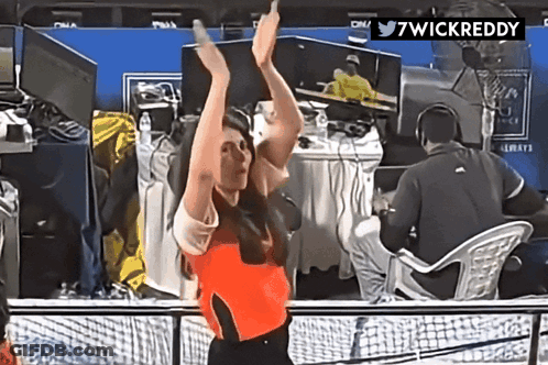 A Woman With Her Arms In The Air Is Dancing In Front Of A Twitter Logo That Says 7Wickreddy GIF