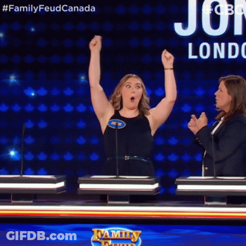 A Woman With Her Arms In The Air On A Family Feud Game Show GIF